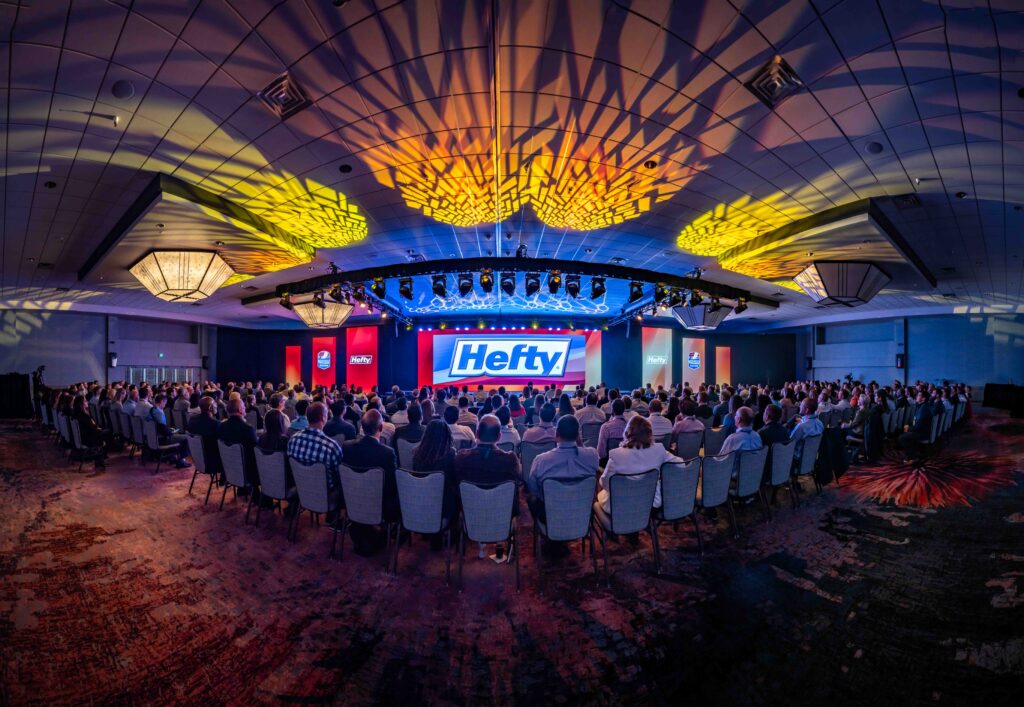 A Panorama of the ballroom with the Hefty logo displayed on the LED wall. 